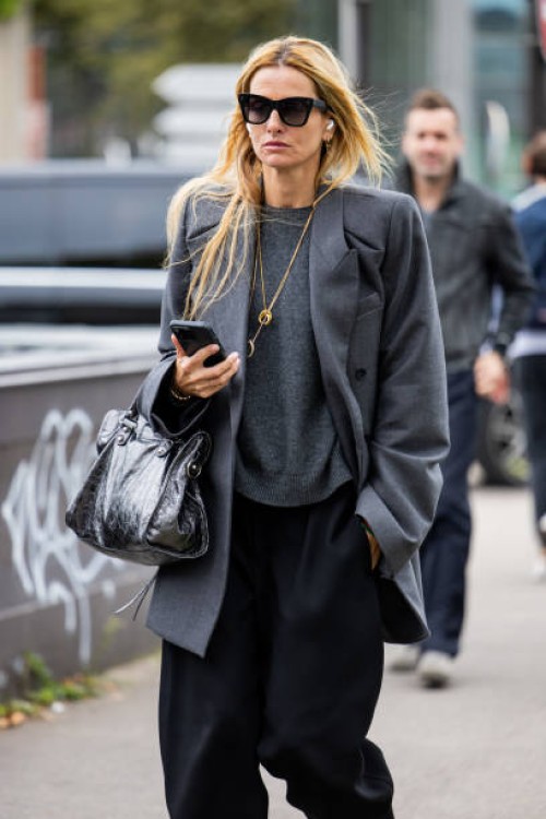 Guest wears grey blazer outside Valentino during Womenswear Spring/Summer 2025 as part of Paris Fashion Week on September 29, 2024 in Paris, France.