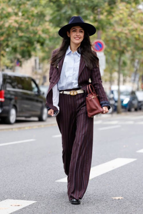 Guest wears light blue shirt, burgundy striped suit, blue hat, burgundy Hermes bag, outside Shiatzy Chen, during Womenswear Spring/Summer 2025 as...