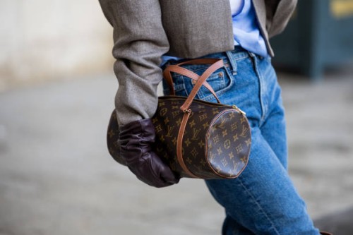 Guest wears Louis Vuitton bag, gloves outside Ziad Nakad during the Haute Couture Spring/Summer 2024 as part of Paris Fashion Week on January 24,...