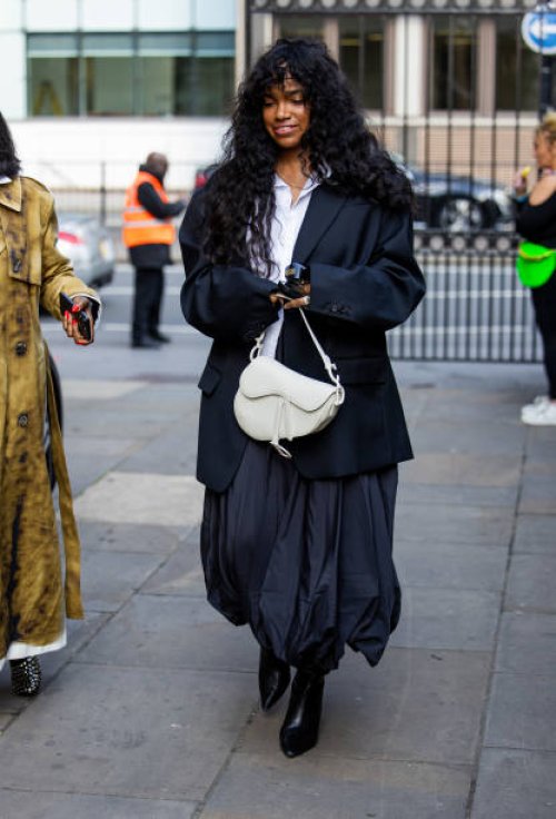 Guest wears oversized blazer, skirt, white Dior bag outside JW Anderson during London Fashion Week September 2024 on September 15, 2024 in London,...