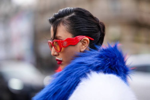Guest wears red sunglasses from Casablanca, outside Casablanca, during the Womenswear Fall/Winter 2024/2025 as part of Paris Fashion Week on February...