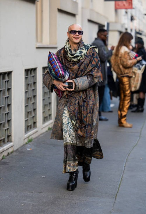 Guest wears scarf with print, coat, skirt outside Pierre-Louis Mascia during the Milan Fashion Week Menswear Fall/Winter 2025-2026 on January 17,...