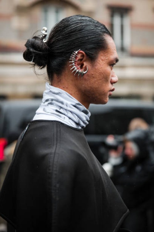 Guest, wears silver ear cuff, outside Vivienne Westwood, during the Womenswear Fall/Winter 2024/2025 as part of Paris Fashion Week on March 02, 2024...
