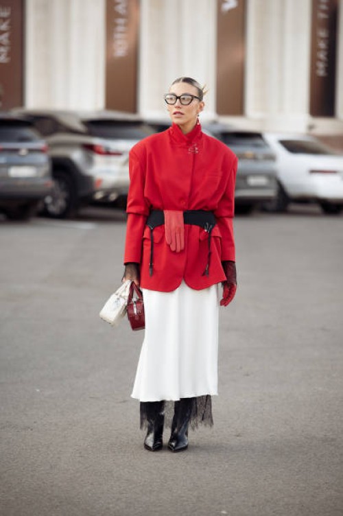 Guest wears white long skirt, red jacket, long black boots, white and red bags, black belt and one red glove during the 10th season of the Visa...