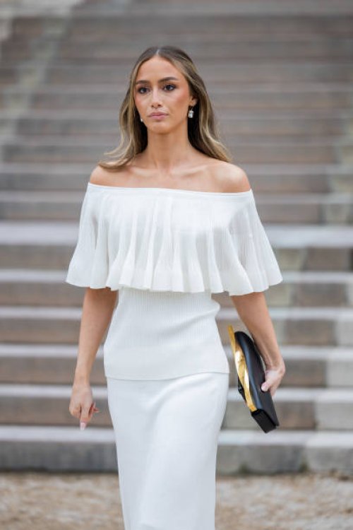 Guest wears white off shoulder dress outside Zimmermann during the Womenswear Fall/Winter 2025/2026 as part of Paris Fashion Week on March 10, 2025...