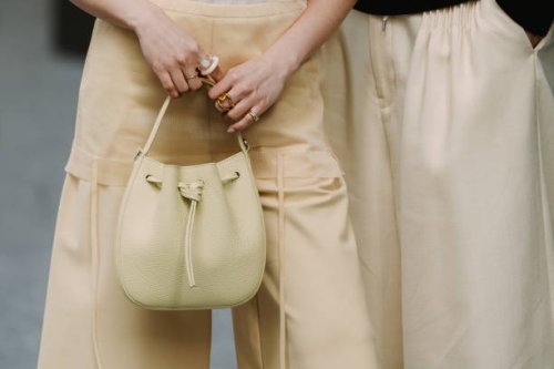 Guests are seen wearing a beige handbag, beige trousers; beige trousers during Rakuten Tokyo Fashion Week A/W 2025 on March 22, 2025 in Tokyo, Japan.