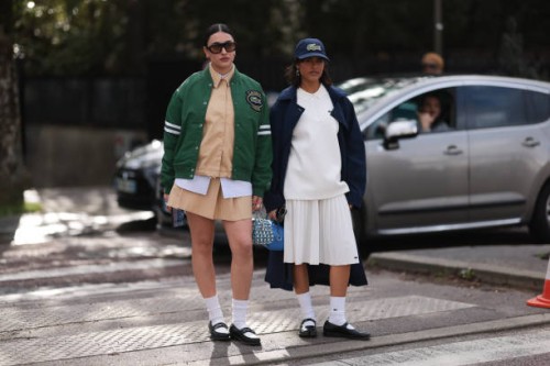 Guests seen wearing a green college jacket, brow blouse with white details, matching skirt, white socks and black leather shoes and shades and a...