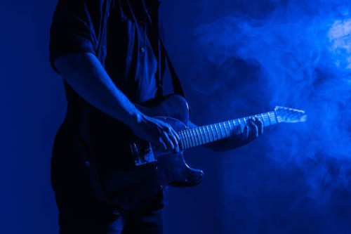 guitar advertising banner. male guitarist plays music in neon light with smoke. - concert stock pictures, royalty-free photos & images