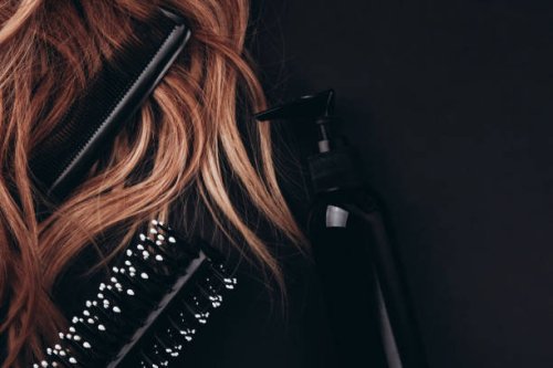 hairbrush and hair comb in long hair near styling foam. - hairstyle stockfoto's en -beelden
