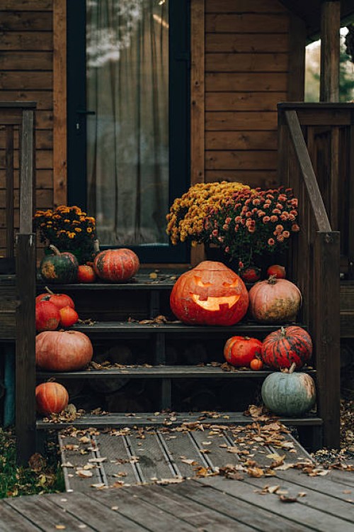 halloween jack-o'-lantern and pumpkins decorating a wooden porch - garden decoration stock pictures, royalty-free photos & images