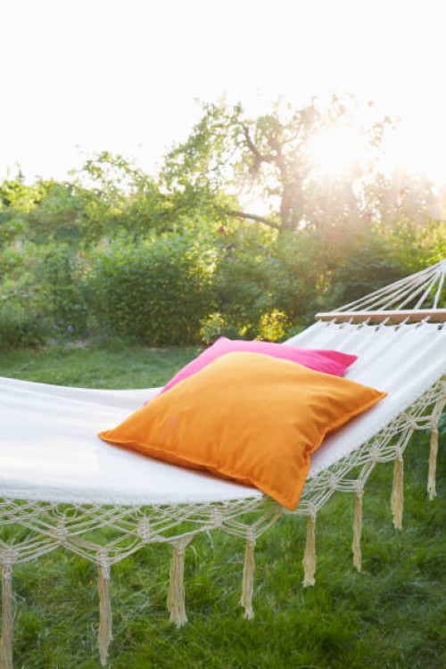 hammock with pillows in garden at sunset - home decoration stock pictures, royalty-free photos & images