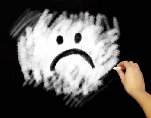 hand drawing sad face with chalk in black board - junk food stock pictures, royalty-free photos & images