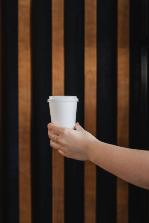hand holding a glass of take away coffee - junk food stock pictures, royalty-free photos & images