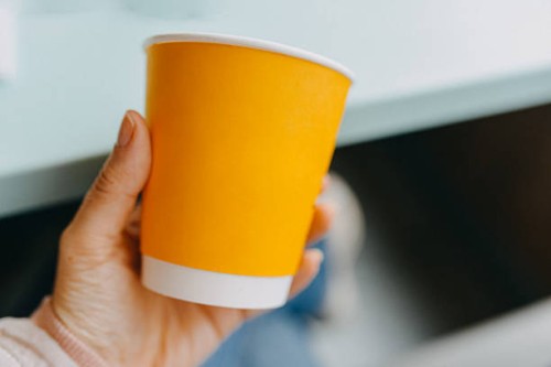 hand holding a paper cup - junk food stock pictures, royalty-free photos & images