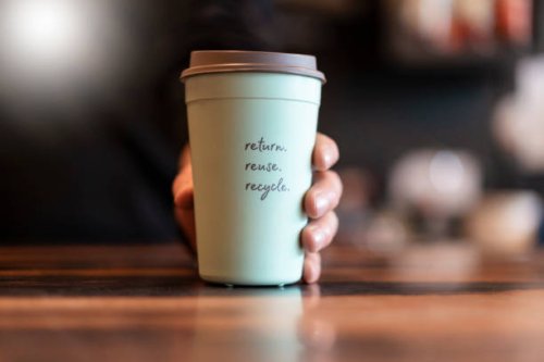 hand holding deposit cup for coffee to go, close-up - junk food stock pictures, royalty-free photos & images