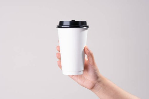 hand holding white paper cup - junk food stock pictures, royalty-free photos & images