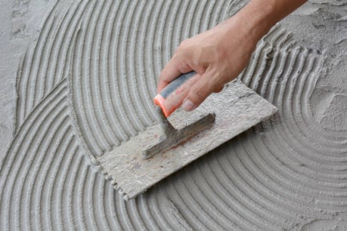 hand on be bound with cement , do cement work, apply cement (over a surface) - home decoration stock pictures, royalty-free photos & images