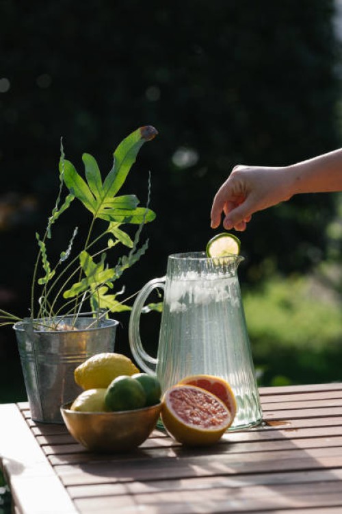 hand preparing a lemonade with grapefruit. stock photo - garden decoration stock pictures, royalty-free photos & images