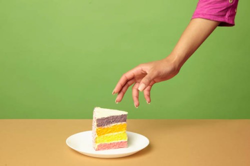 hand reaching for cake - junk food stock pictures, royalty-free photos & images