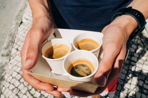 hands holding coffee cups: high angle view of young adult holding disposable coffee cups - junk food stock pictures, royalty-free photos & images