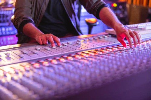 hands of a male audio engineer adjusting the sound on a audio mixer in a recording studio - concert stock pictures, royalty-free photos & images