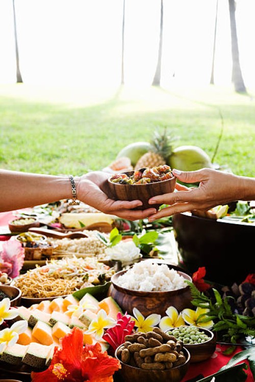 hands passing bowl at hawaiian picnic - food stock pictures, royalty-free photos & images