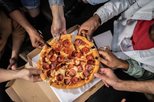 hands picking pizza slices - junk food stock pictures, royalty-free photos & images