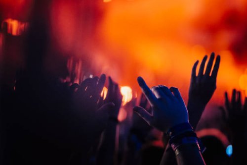 hands raised, cheering in concert audience - concert stock pictures, royalty-free photos & images