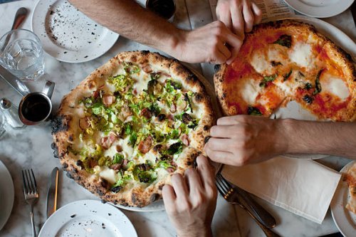 hands reach for naples-style pizza - food stock pictures, royalty-free photos & images