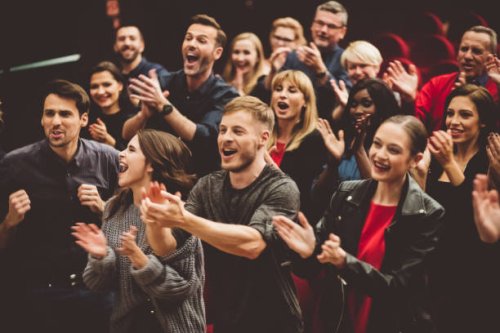 happy audience applauding in the theater - concert stock pictures, royalty-free photos & images