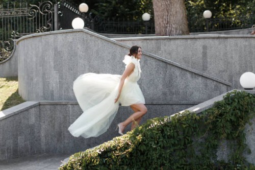 happy beautiful bride walks up the stairs - fashion stock pictures, royalty-free photos & images
