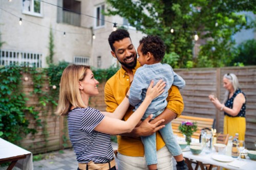 happy biracial family with small son during family dinner outdoors in garden. - garden decoration photos et images de collection