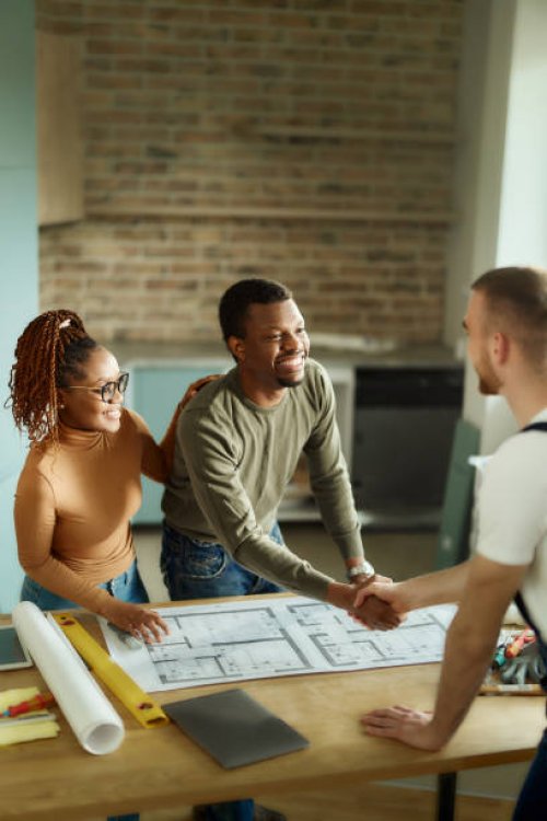 happy black couple shaking hands with manual worker in moving house. - home decoration stock pictures, royalty-free photos & images
