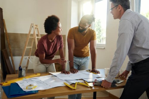 happy black couple talking while analyzing housing plan with an architect. - home decoration stock pictures, royalty-free photos & images