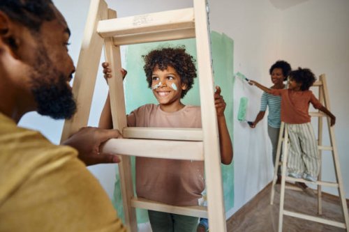 happy black father and son talking through ladders during home renovation process. - home decoration stock pictures, royalty-free photos & images