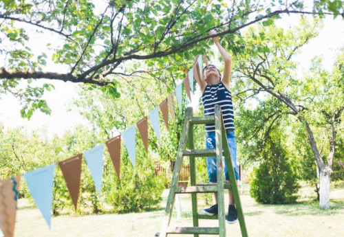 happy boy preparing a party event - garden decoration stock pictures, royalty-free photos & images