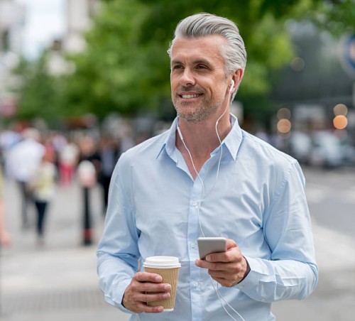 happy business man listening to music outdoors - junk food stock pictures, royalty-free photos & images