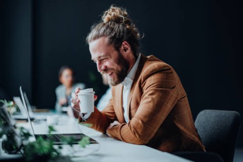 happy business man working on a laptop computer in the office - junk food stock pictures, royalty-free photos & images