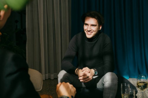 happy businessman with hands clasped talking to colleague during event at convention center - fashion stock pictures, royalty-free photos & images