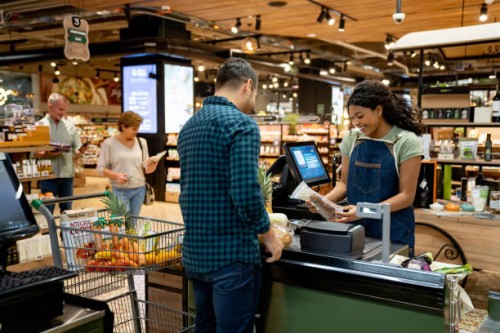 happy cashier working at the supermarket registering products - food stock pictures, royalty-free photos & images