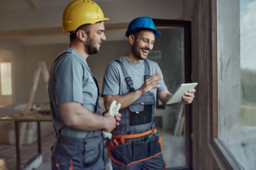 happy construction workers using touchpad at renovating house. - home decoration stock pictures, royalty-free photos & images