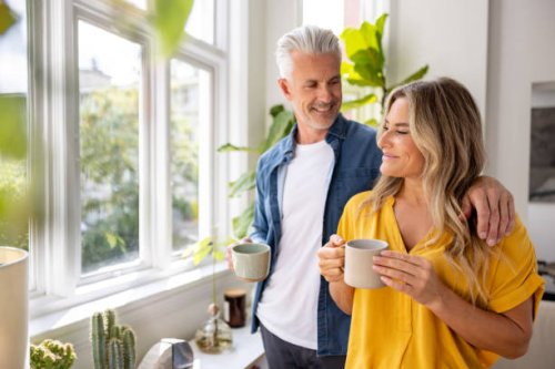 happy couple at home drinking a cup of coffee - coffee stock pictures, royalty-free photos & images