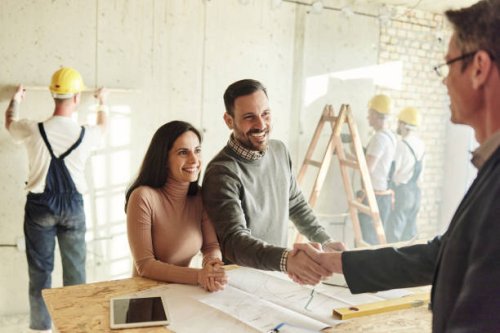happy couple came to an agreement with agent at construction site. - home decoration stock pictures, royalty-free photos & images