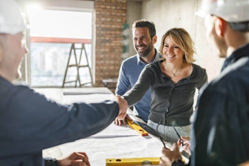 happy couple closed a deal with manual workers at construction site. - home decoration stock pictures, royalty-free photos & images