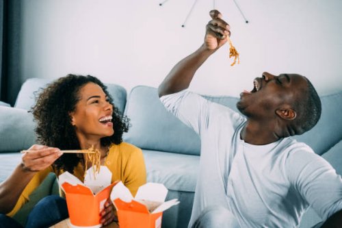 happy couple eating chinese food at home. - junk food stock pictures, royalty-free photos & images