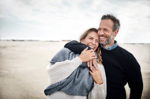 happy couple hugging on the beach - travel stock pictures, royalty-free photos & images