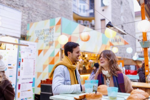 happy couple laughing during dinner near food truck - junk food stock pictures, royalty-free photos & images