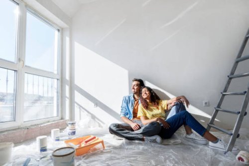 happy couple sitting on floor at new home - home decoration stock pictures, royalty-free photos & images