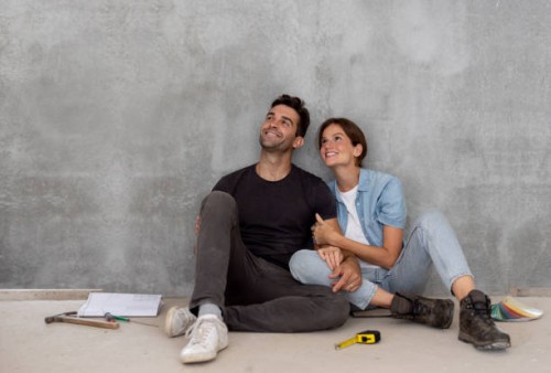 happy couple taking a break from building their house - home decoration stock pictures, royalty-free photos & images