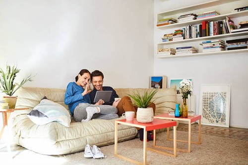 happy couple video chatting on digital tablet - home decoration stock pictures, royalty-free photos & images